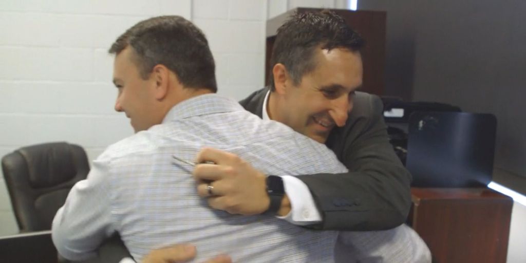 Glenn Barton hugs Rory Graves in the Mobile Homicide office