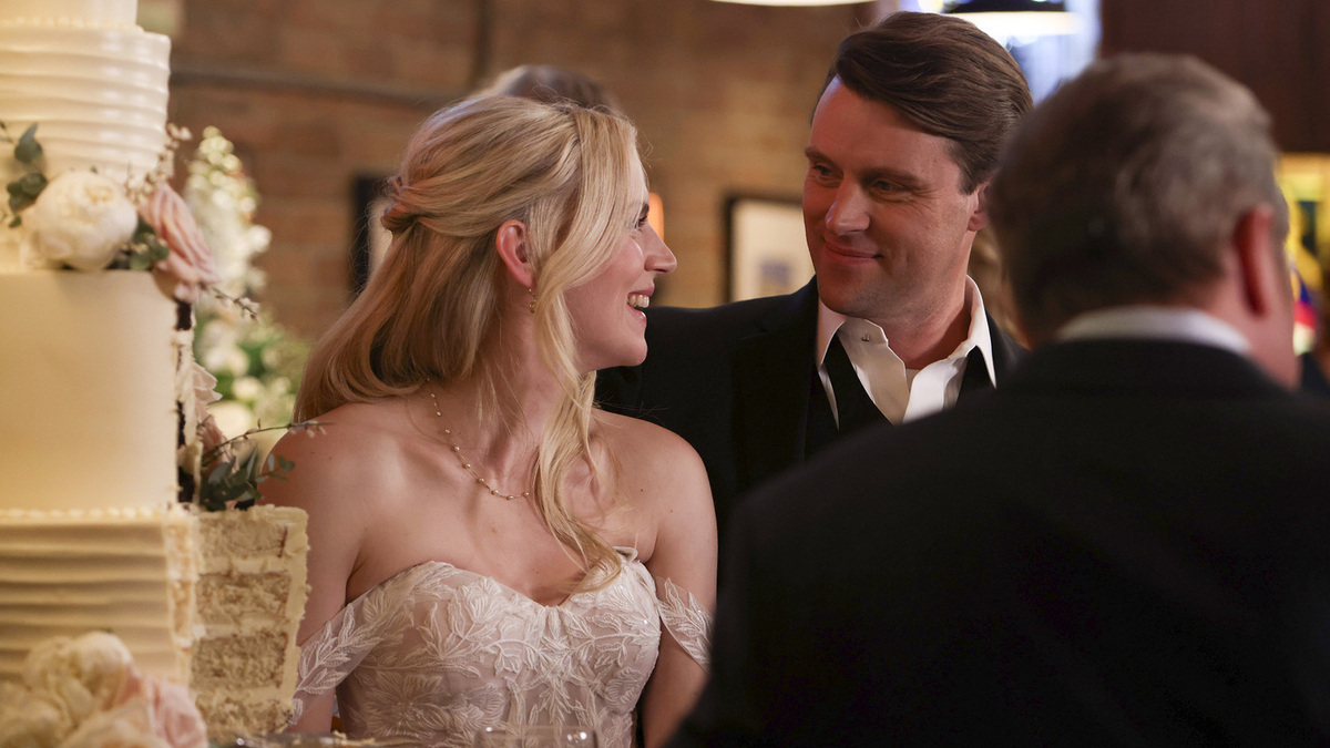 Casey smiles at Brett next to their wedding cake on Chicago Fire