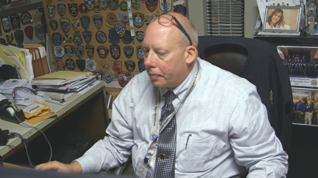 Detective Jason White of Tulsa Homicide sits at his desk in The First 48 Season 28, Episode 3, "Broken Youth." (Photo Credit: Screenshot/Courtesy of A&E.)