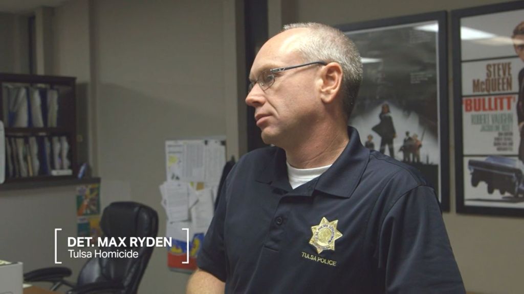 Detective Max Ryden of Tulsa Homicide stands listening in The First 48 Season 28, Episode 3, "Broken Youth." (Photo Credit: Screenshot/Courtesy of A&E.)