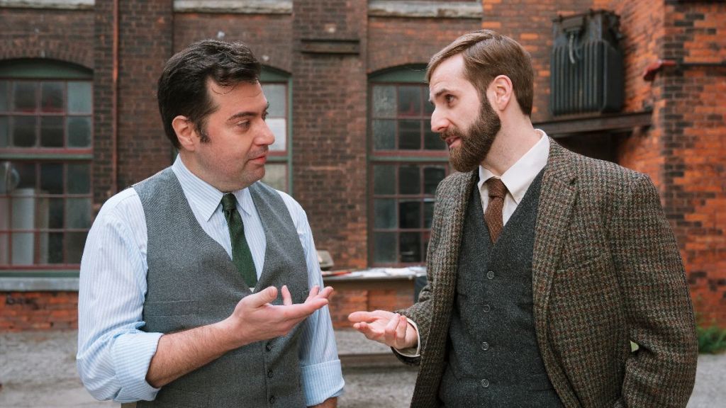 Harvey Firestone tasks top Firestone engineer, John Thomas to design a tire so easy to remove anyone can do it in The Mega-Brands That Built America. (Photo Credit: A&E Television Networks/Lucky8, Courtesy of HISTORY.)