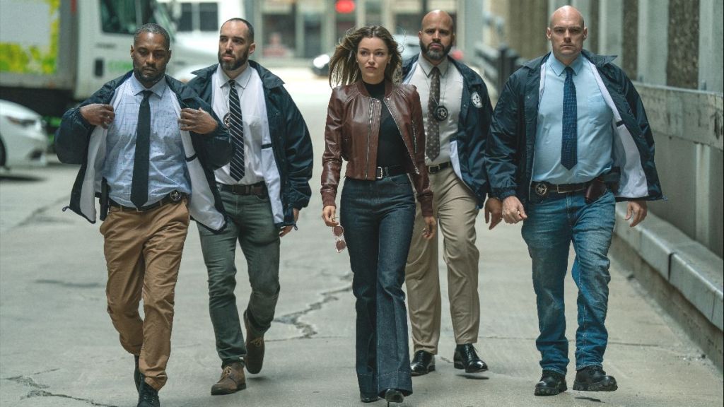 Actor Lilli Simmons as Claudia Flynn, surrounded by federal agents, in Power Book IV: Force season 3 episode 4. (Photo Credit: Courtesy of Starz.)