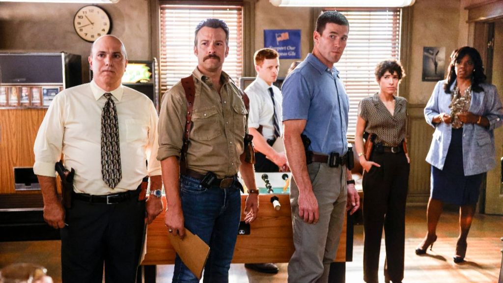 The NIS agents gather in the bullpen during NCIS: Origins season 2, episode 7. (Photo Credit: Courtesy of CBS.)